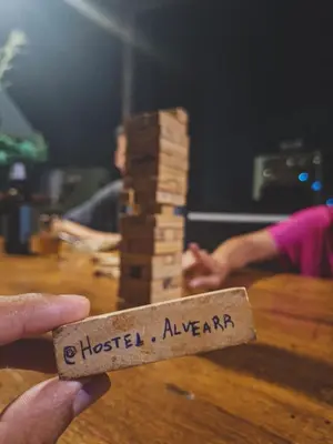 a person holding a piece of wood with the words hottestagencyagency at Hostel Alvear in Cordoba