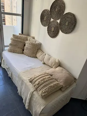 a bedroom with a bed with pillows and hats on the wall at Tránsito in Cordoba