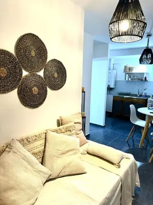 a living room with a couch and baskets on the wall at Tránsito in Cordoba