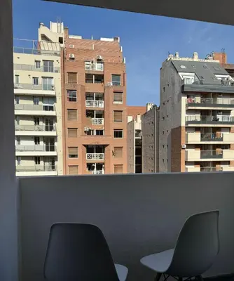 two chairs in a room with a view of buildings at Tránsito in Cordoba