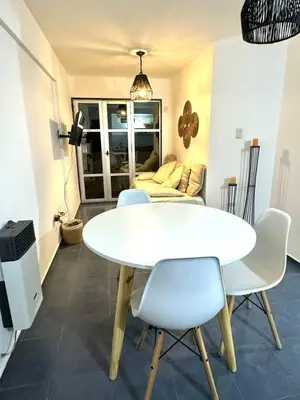 a dining room with a white table and chairs at Tránsito in Cordoba