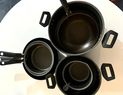 three pots and pans sitting on top of a stove at Tránsito in Cordoba