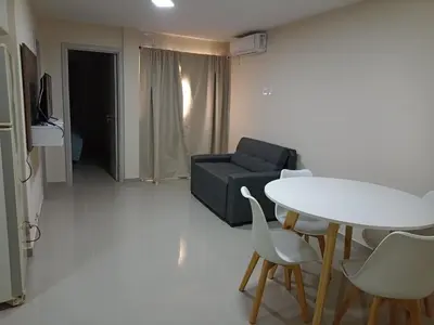 a living room with a couch and a table and chairs at Cálido departamento en la mejor zona de Alta Córdoba in Cordoba