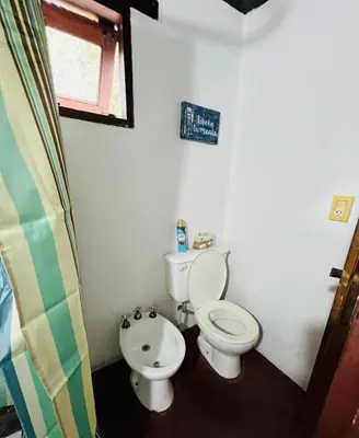 a bathroom with a toilet and a bidet at Cabañas La Felicidad in Merlo