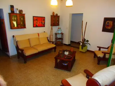 a living room with a couch and a table at Hotel Complejo Najul Suites-Solo Adultos in Mina Clavero