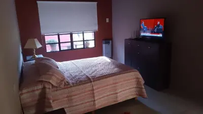 a bedroom with a bed and a television in it at Achaval-Torre in Cordoba