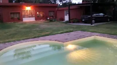 a swimming pool in the yard of a house at night at Achaval-Torre in Cordoba
