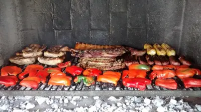 a grill with meat and other meats and vegetables at Achaval-Torre in Cordoba