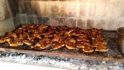 a bunch of chickens cooking on a grill at Achaval-Torre in Cordoba