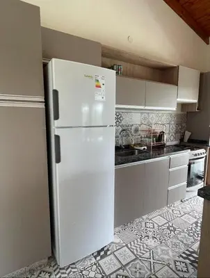a white refrigerator in a kitchen with a tile floor at Casa Reartes in Los Reartes