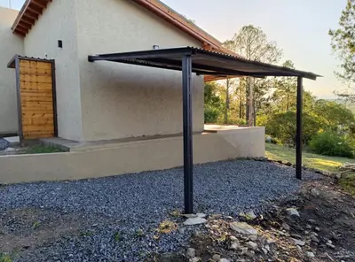 a black umbrella in front of a house at Casa Reartes in Los Reartes