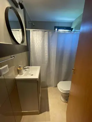 a bathroom with a toilet and a sink and a mirror at Casa Reartes in Los Reartes