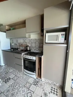 a kitchen with a microwave oven and a refrigerator at Casa Reartes in Los Reartes