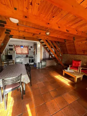a kitchen with a table and chairs in a room at Alpinas San Lorenzo in Merlo