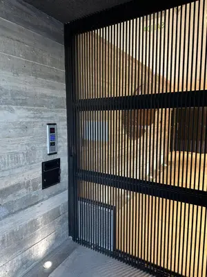 a wooden wall with a gate in a building at Magnolia in Cordoba