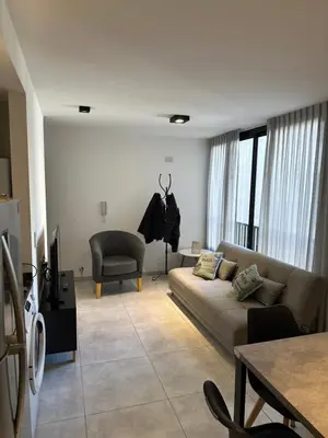 a living room with a couch and a chair at Magnolia in Cordoba