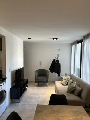 a living room with a couch and a chair at Magnolia in Cordoba