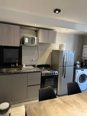 a kitchen with a stainless steel refrigerator and a dishwasher at Magnolia in Cordoba