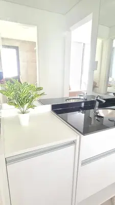 a white kitchen with a sink and a potted plant at Sundara Tan perfecto que no vas a querer irte in Villa Carlos Paz