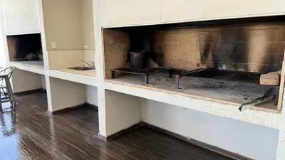 a brick fireplace in a room with a sink at Sundara Tan perfecto que no vas a querer irte in Villa Carlos Paz
