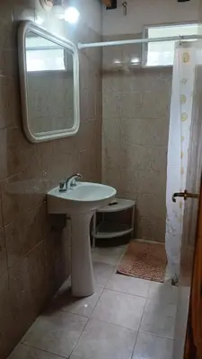 a bathroom with a sink and a mirror at Cabañas El Duende in Quines