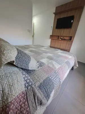 a bedroom with a bed with a tv on it at Departamento -Roma- Barrio General Paz - A una cuadra de 24 de septiembre y enfrente del Polideportivo By Apartcba in Cordoba
