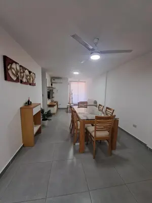 a living room with a dining room table and chairs at Departamento -Roma- Barrio General Paz - A una cuadra de 24 de septiembre y enfrente del Polideportivo By Apartcba in Cordoba