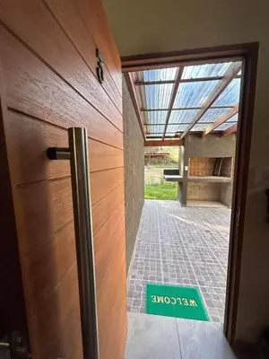a door with a sign that at Cabañas La Arbolada in El Durazno