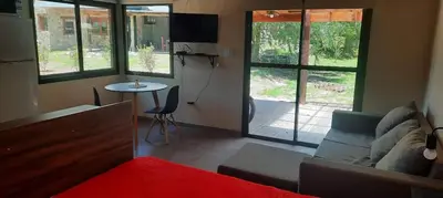 a living room with a couch and a table at Cabañas La Arbolada in El Durazno