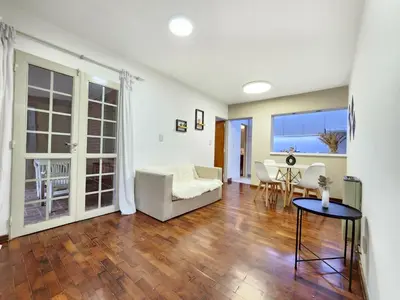 a living room with a couch and a table at Departamento PB, patio y asador privados - NUEVO SERVICIO Estacionamiento 24hs INCLUIDO, no camioneta- Cerca de hotel Quinto Centenario, Nuevocentro shopping, Hospital Clinicas y Club Universitario Córdoba Sede central in Cordoba
