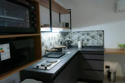 a kitchen with a counter top with a stove at JC Apart in Cordoba