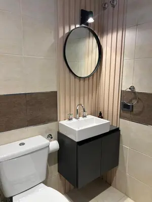 a bathroom with a sink and a toilet and a mirror at JC Apart in Cordoba
