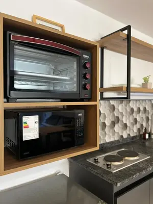 a microwave oven sitting inside of a kitchen at JC Apart in Cordoba