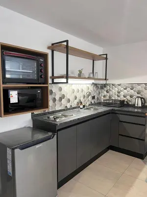 a kitchen with a stove and a microwave at JC Apart in Cordoba