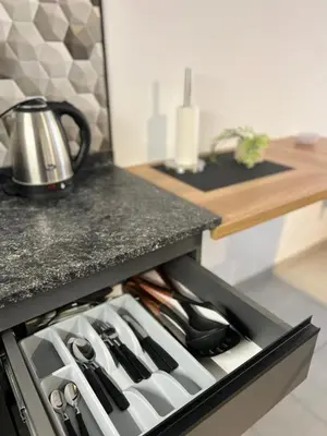 a drawer filled with utensils in a kitchen at JC Apart in Cordoba