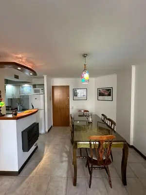 a kitchen and a dining room with a table and chairs at Departamento Nueva Córdoba 7 A INVERHOME INMOBILIARIA in Cordoba