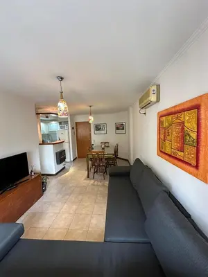 a living room with a couch and a dining room at Departamento Nueva Córdoba 7 A INVERHOME INMOBILIARIA in Cordoba