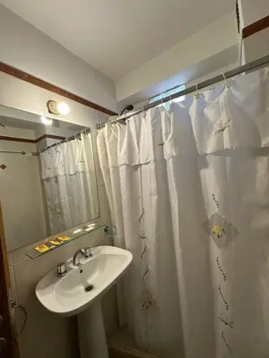 a bathroom with a sink and a shower curtain at Departamento Nueva Córdoba 7 A INVERHOME INMOBILIARIA in Cordoba