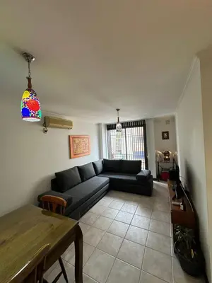 a living room with a couch and a table at Departamento Nueva Córdoba 7 A INVERHOME INMOBILIARIA in Cordoba