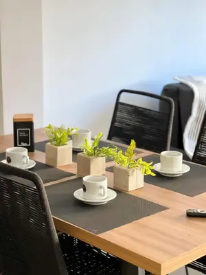 a table with cups and saucers and plants on it at JC Apart 3 in Cordoba