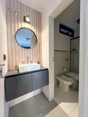 a bathroom with a sink and a toilet and a mirror at JC Apart 3 in Cordoba
