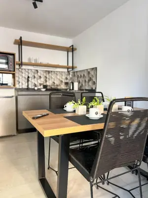 a kitchen with a table and chairs in a kitchen at JC Apart 3 in Cordoba