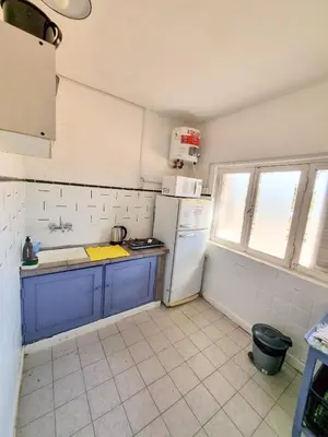 a kitchen with a white refrigerator and a window at Casa Irupé in Embalse