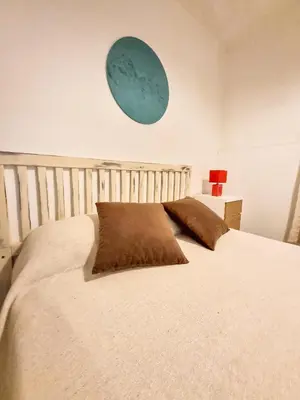 a bedroom with a large bed with two pillows on it at Casa Irupé in Embalse