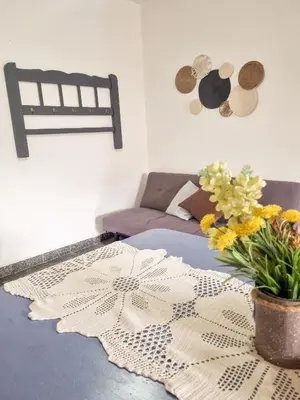 a room with a bed with a table with flowers on it at Casa Irupé in Embalse