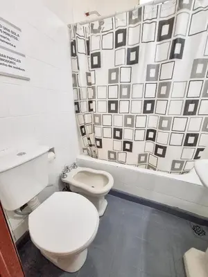 a bathroom with two toilets and a shower curtain at Casa Irupé in Embalse
