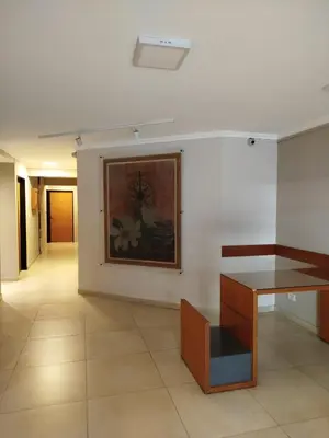 a room with a painting on the wall and a table at Obispo Oro Departamento Temporario Córdoba in Cordoba
