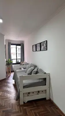 a white bedroom with a bed and a window at Obispo Oro Departamento Temporario Córdoba in Cordoba