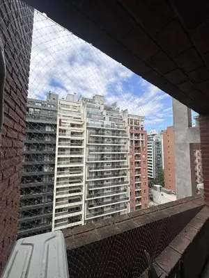 a view of a large building from a balcony at Obispo Oro Departamento Temporario Córdoba in Cordoba