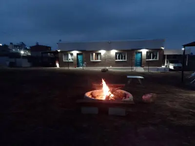a fire pit in front of a house at night at Portal del Sol in Villa Yacanto